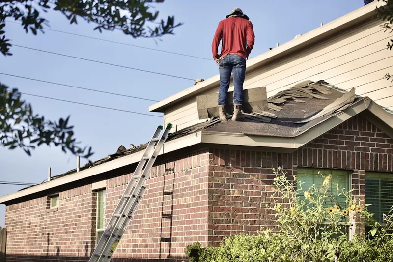 Professional roofer working on a residential roof in Dellwood